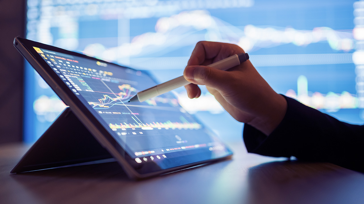 Un analista valuta l'andamento dei mercati tramite tablet